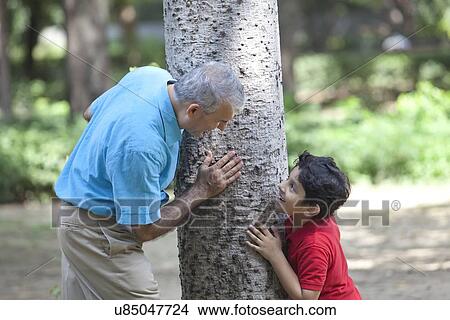 Grandfather and grandson playing hide and seek View Large Photo Image Picture - Grandfather and grandson playing hide and seek. Fotosearch