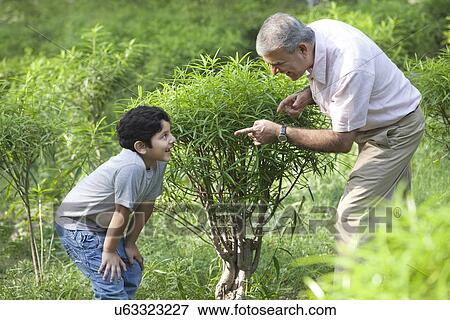Stock Photo - Grandfather and grandson playing hide and seek. Fotosearch