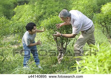 Stock Photography - Grandfather and grandson playing in a park. Fotosearch