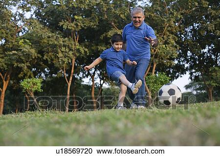 Grandfather and grandson playing soccer View Large Photo Image Stock Image - Grandfather and grandson playing soccer. Fotosearch