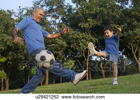 Grandfather and grandson playing soccer View Large Photo Image Stock Image - Grandfather and grandson playing soccer. Fotosearch