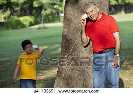 Grandfather and grandson talking through paper cups View Large Photo Image Stock Image - Grandfather and grandson talking through paper cups. Fotosearch