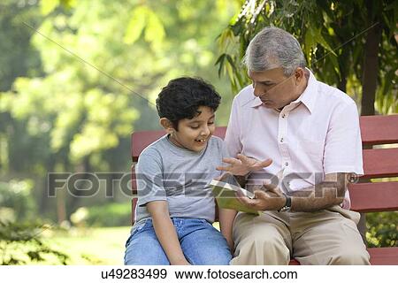 Stock Photo - Grandfather and grandson with a book. Fotosearch