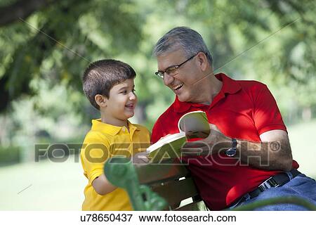 Grandfather and grandson with a book View Large Photo Image Stock Photo - Grandfather and grandson with a book. Fotosearch