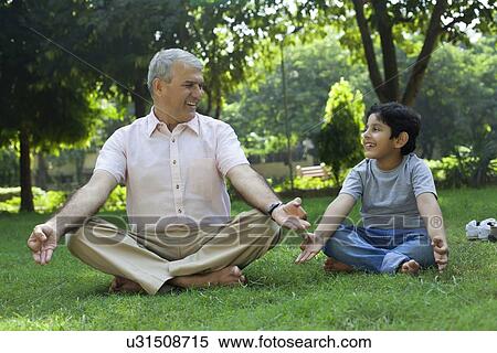 Grandfather meditating with grandson View Large Photo Image Stock Photography - Grandfather meditating with grandson. Fotosearch