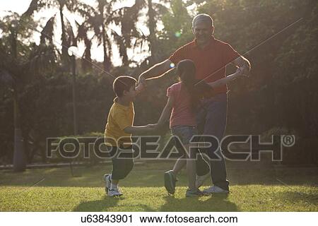 Grandfather playing with his grandchildren View Large Photo Image Stock Image - Grandfather playing with his grandchildren. Fotosearch