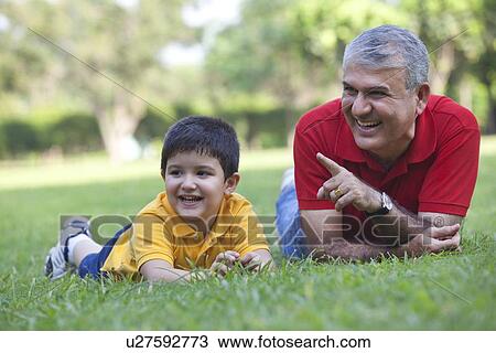 Grandfather pointing something out to grandson View Large Photo Image Stock Image - Grandfather pointing something out to grandson. Fotosearch