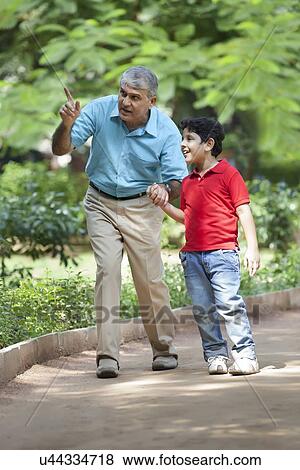 Grandfather pointing something out to grandson View Large Photo Image Stock Photo - Grandfather pointing something out to grandson. Fotosearch