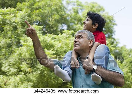 Grandfather pointing something out to grandson View Large Photo Image Stock Photography - Grandfather pointing something out to grandson. Fotosearch
