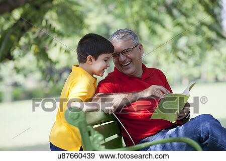 Grandfather showing book to grandson View Large Photo Image Stock Photo - Grandfather showing book to grandson. Fotosearch