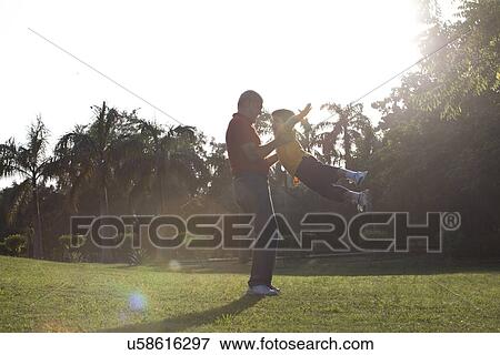 Grandfather swinging his grandson View Large Photo Image Stock Photo - Grandfather swinging his grandson. Fotosearch