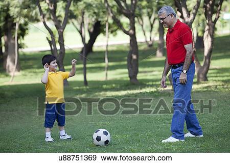 Stock Photo - Grandson and grandfather in a park. Fotosearch