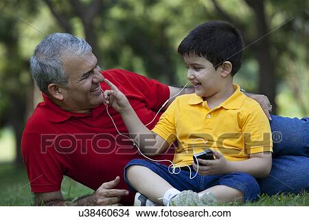 Grandson touching his grandfathers nose View Large Photo Image Picture - Grandson touching his grandfathers nose. Fotosearch