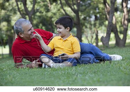 Stock Image - Grandson touching his grandfathers nose. Fotosearch