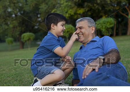 Grandson touching his grandfathers nose View Large Photo Image Stock Photograph - Grandson touching his grandfathers nose. Fotosearch