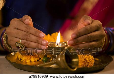 Hands cupped around a diya View Large Photo Image Stock Photo - Hands cupped around a diya . Fotosearch