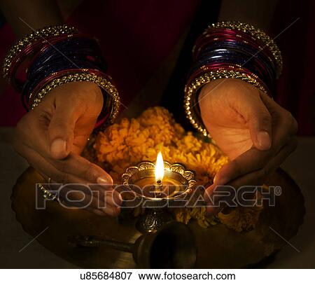Hands cupped around a diya View Large Photo Image Stock Photo - Hands cupped around a diya . Fotosearch
