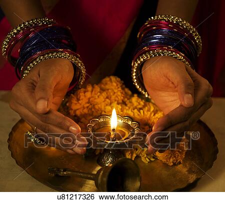 Hands cupped around a diya View Large Photo Image Stock Photograph - Hands cupped around a diya . Fotosearch