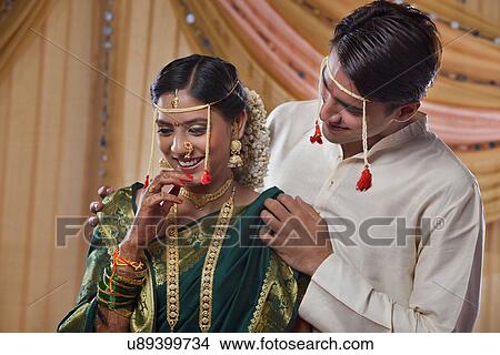 Picture - Handsome groom looking at beautiful bride . Fotosearch