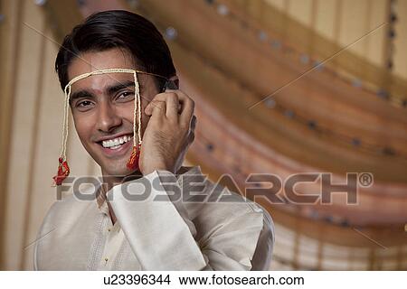 Handsome young man speaking on mobile phone View Large Photo Image Picture - Handsome young man speaking on mobile phone . Fotosearch