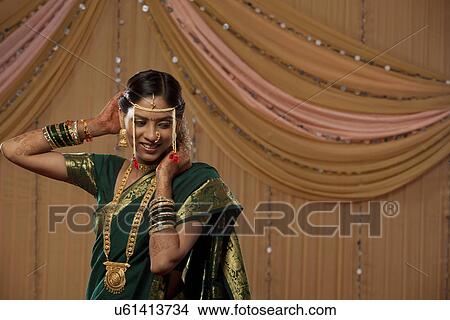 Picture - Happy beautiful bride getting dressed . Fotosearch