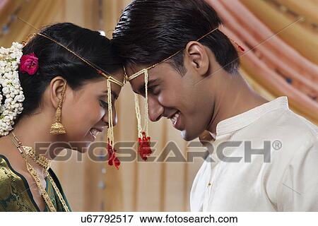 Stock Photo - Happy Maharashtrian bride and groom looking at each other . Fotosearch