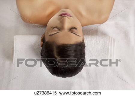 High angle view of woman lying on message bed View Large Photo Image Stock Photography - High angle view of woman lying on message bed . Fotosearch