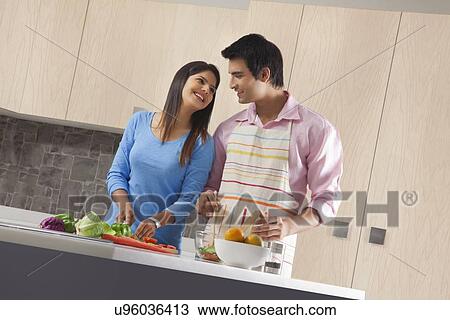 Indian couple preparing vegetable salad in kitchen View Large Photo Image Stock Image - Indian couple preparing vegetable salad in kitchen. Fotosearch