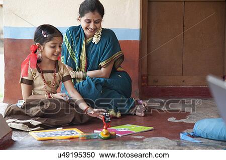 Little girl playing with a toy View Large Photo Image Stock Image - Little girl playing with a toy . Fotosearch