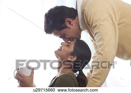 Man kissing a woman on her forehead View Large Photo Image Stock Image - Man kissing a woman on her forehead. Fotosearch
