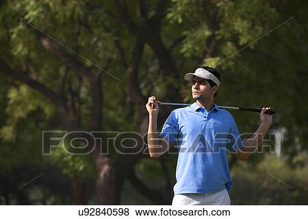 Man posing with a golf club View Large Photo Image Stock Photo - Man posing with a golf club . Fotosearch