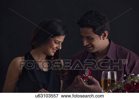 Man proposing to woman on Valentines Day View Large Photo Image Stock Photo - Man proposing to woman on Valentines Day. Fotosearch