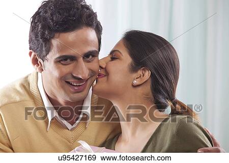 Stock Photo - Man receiving a kiss from a woman on Valentines Day. Fotosearch
