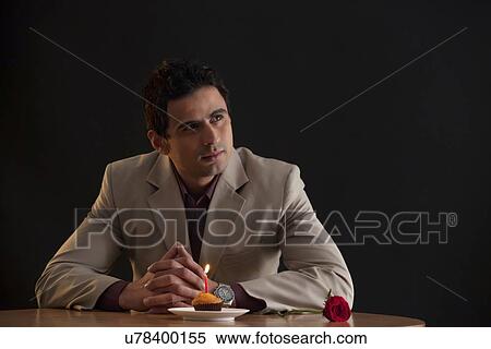 Stock Photography - Man thinking while on a date. Fotosearch