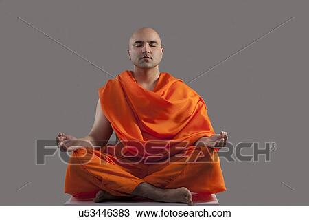 Stock Image - Monk meditating . Fotosearch