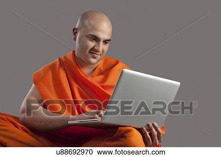 Monk with a laptop View Large Photo Image Stock Image - Monk with a laptop . Fotosearch