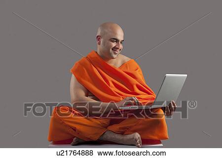 Monk with a laptop View Large Photo Image Stock Photo - Monk with a laptop . Fotosearch