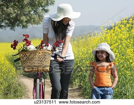 Stock Image - Mother and daughter in a field . Fotosearch
