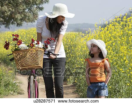 Mother and daughter in a field View Large Photo Image Stock Image - Mother and daughter in a field . Fotosearch