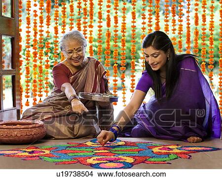 Mother and daughter making a rangoli View Large Photo Image Picture - Mother and daughter making a rangoli . Fotosearch