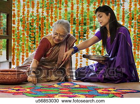 Mother and daughter making a rangoli View Large Photo Image Stock Image - Mother and daughter making a rangoli . Fotosearch