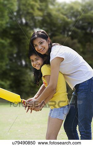 Mother and daughter playing cricket View Large Photo Image Stock Image - Mother and daughter playing cricket . Fotosearch