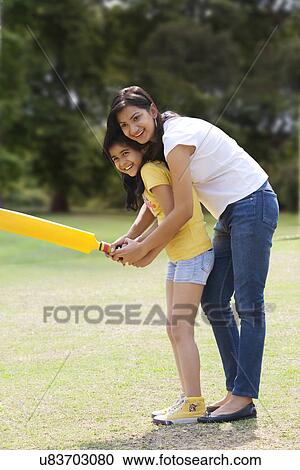 Mother and daughter playing cricket View Large Photo Image Stock Image - Mother and daughter playing cricket . Fotosearch
