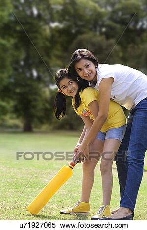 Mother and daughter playing cricket View Large Photo Image Stock Photography - Mother and daughter playing cricket . Fotosearch