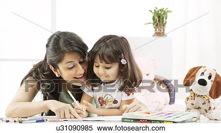 Mother and daughter with a colouring book View Large Photo Image Stock Photography - Mother and daughter with a colouring book . Fotosearch