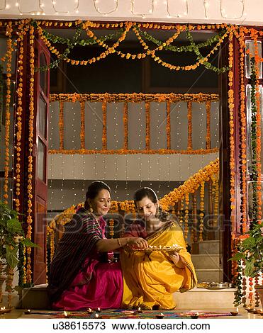 Mother and daughter with a tray of diyas View Large Photo Image Stock Image - Mother and daughter with a tray of diyas . Fotosearch