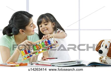 Mother and daughter with an abacus View Large Photo Image Picture - Mother and daughter with an abacus . Fotosearch