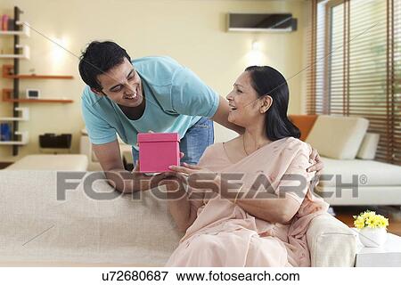 Mother and son exchanging gift View Large Photo Image Stock Photo - Mother and son exchanging gift . Fotosearch