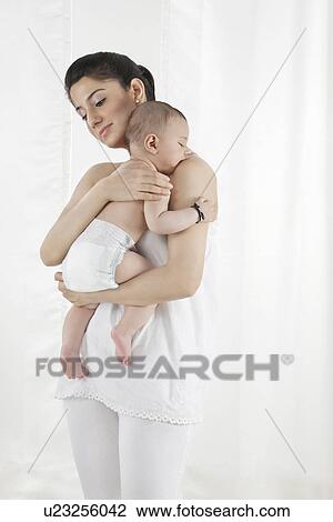 Mother holding a sleeping baby View Large Photo Image Stock Image - Mother holding a sleeping baby . Fotosearch