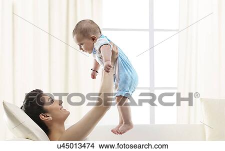 Mother holding her baby View Large Photo Image Picture - Mother holding her baby . Fotosearch